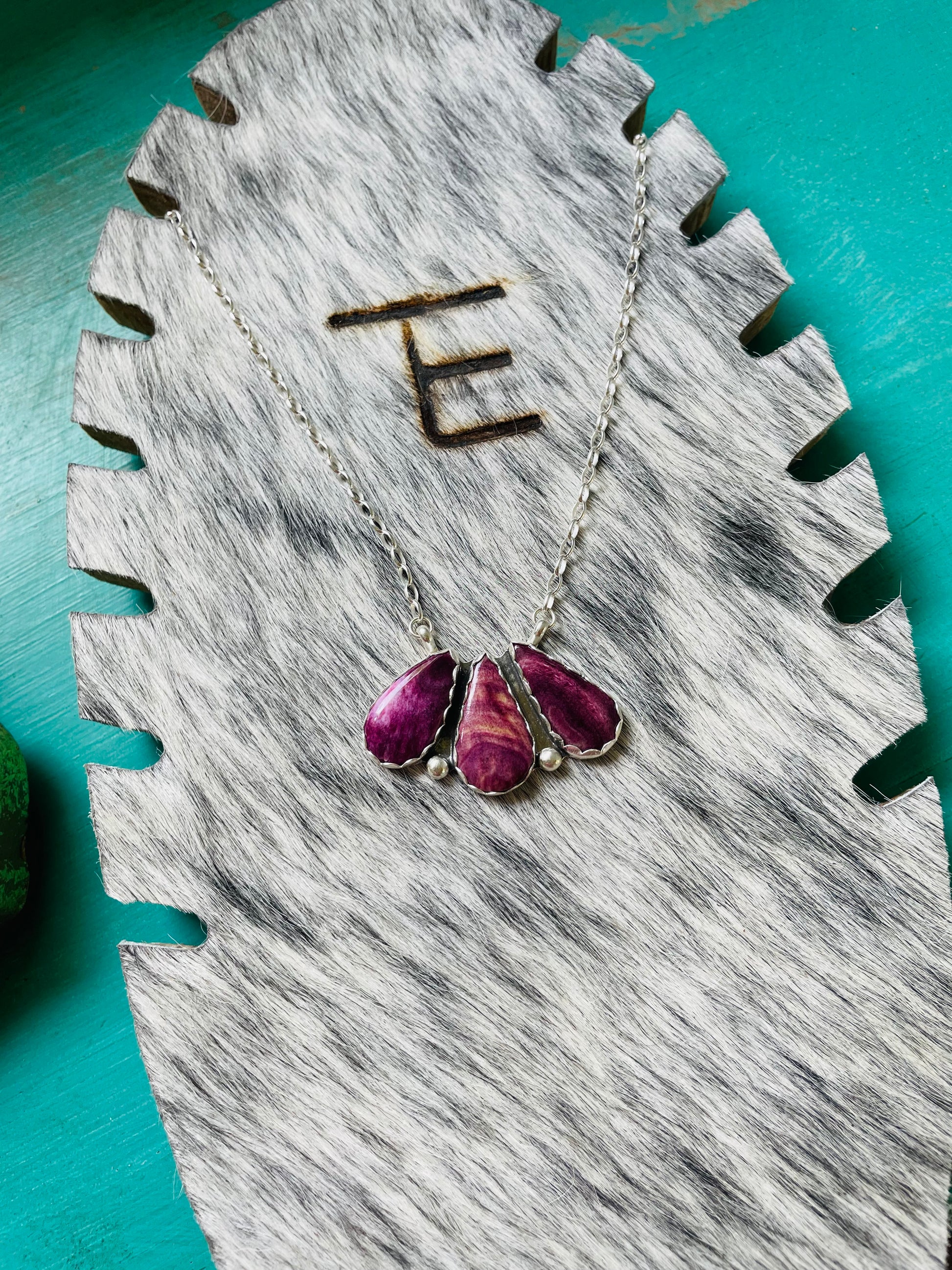 purple spiny oyster, spiny oyster necklace, purple western necklace, three stone cluster pendant, teardrop stone jewelry, magenta southwestern necklace, cowgirl jewelry aesthetic, artisan silver necklace, homegrown collection, unique western fashion, handcrafted silversmith